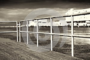 Quay border fence in sepia background
