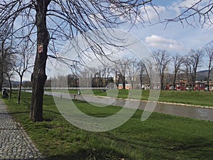 Quay on Nisava river, footbridge in background, Pirot, Serbia