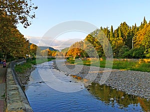 Quay of the river, yellow leaves on plane trees, autumn landscape