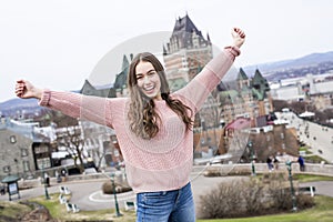 Quebec City scape with Chateau Frontenac and young teen enjoying the view.