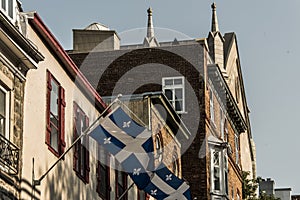 Quebec flag in front of a old house of the older part of Quebec City in the Lower Town - basse ville