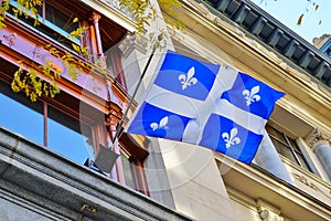A Quebec flag with white lily flowers in Montreal, Canada