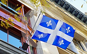 A Quebec flag with white lily flowers in Montreal, Canada