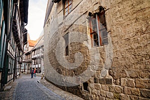 Quedlinburg, Saxony-Anhalt, Germany, 28 October 2022: Alley Hell, oldest stone house in city, figurine of black iron crow with