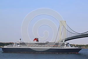 Queen Mary 2 cruise ship in New York Harbor under Verrazano Bridge heading for Canada New England