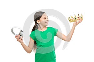 Queen of music. portrait of cheerful girl isolated on white. happy childhood. small girl choose between crown and