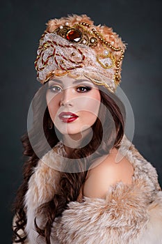 Queen in royal dress. girl in royal hat and fur coat