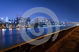 Queensboro Bridge and Queens skyline by the East River, at night, New York City, USA