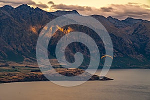 Paragliding over Queenstown and Lake Wakaitipu from viewpoint at Queenstown Skyline, New Zealand