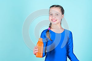 Quench thirst. Child feel thirst after sport training. Kid cute girl gymnast sports leotard hold bottle for drink. Water