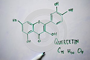 Quercetin C15,H10,O7 molecule written on the white board. Structural chemical formula. Education concept