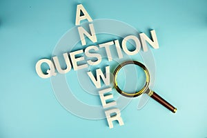 Question and Answer alphabet letters with magnifying glass on blue background