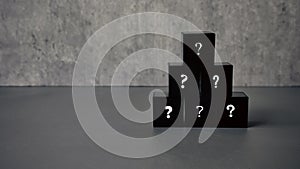 Question and answer concept. Stack of black cube with a symbol of question mark