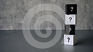Question and answer concept. Stack of black and white cube with a symbol of question mark