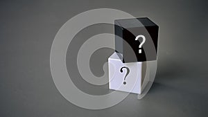 Question and answer concept. Stack of black and white cube with a symbol of question mark