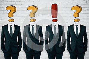 Question and exclamation mark headed businessmen