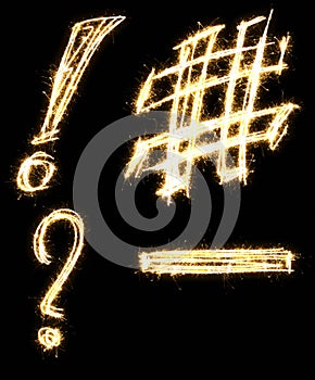 Question and exclamation mark, number and minus sign made by sparkler. Isolated on a black background.