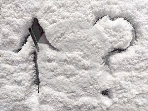 A question mark and arrow written in the snow. The cold frosty texture of the snow and the question mark. Background