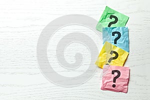 Question mark on colored office note paper. Copy space for text.