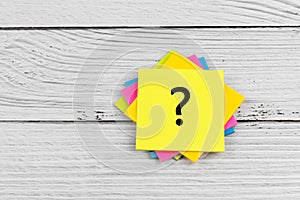 Question mark on colorful adhesive paper note