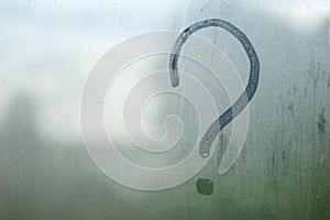 Question mark on the fogged glass