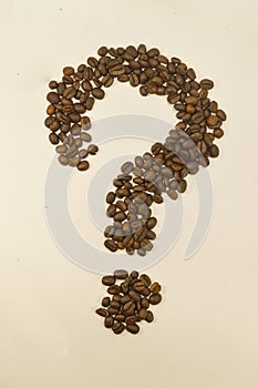 Question mark image made up of coffee beans.