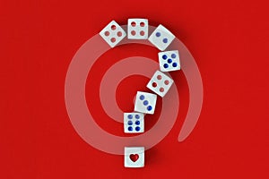 Question mark made of dices and heart on red background - Concept of risk and chance on love