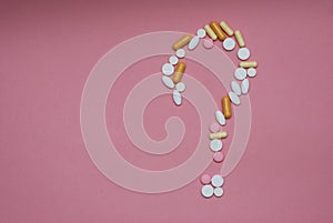 Question mark made by pills on pink background. Creative medicine for health medical problem, drug interaction