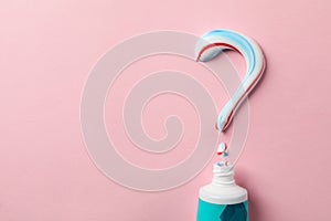 Question mark made of toothpaste and tube on background, copy space