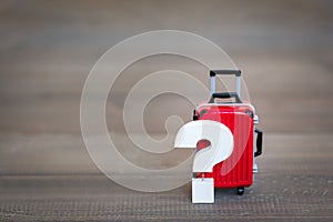 Question mark with Red Luggage Bag on wood table , Problem Concept