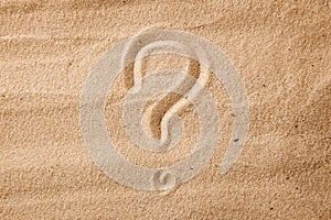 The question mark is sand painted on sand. Symbol of choice and doubt