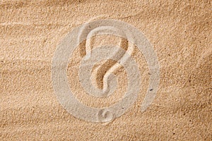 The question mark is sand painted on sand. Symbol of choice and doubt
