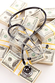 Question Mark Shaped Stethoscope Laying on Money