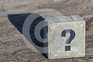 Question mark on a stone