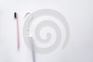 Flat lay composition of the question mark of toothpaste and toothbrush on a white background. Space for text