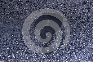 The question mark on the wet glass-Drops of water close up, texture