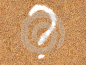 Question mark in wheat grains. Concept of global food scarcity, famine and hunger. Food shortage and supply chain