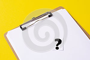 a question mark on a white sheet . FAQ frequency asked questions, Answer and Brainstorming Concepts