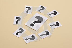 A question mark on a white sheet . FAQ frequency asked questions, Answer, Information and Brainstorming Concepts