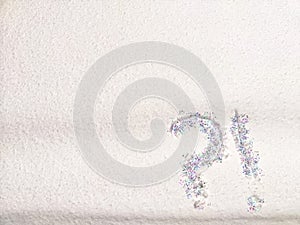 A question mark written on snow with sequins or confetti. The concept of Uncertainty of choice, expectations, and