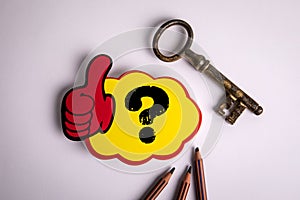 Question mark on a yellow sticky note on a white background