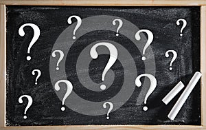 Question marks on blackboard. Business concept