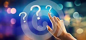 Question marks with hand pressing a button