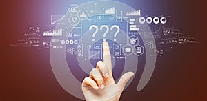 Question marks with hand pressing a button