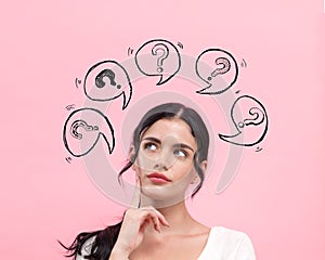 Question marks with speech bubbles with young woman