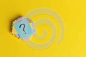 Question marks written reminders tickets on yellow paper background