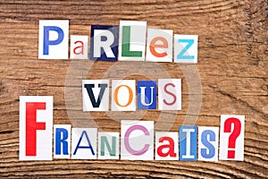 Question `Parlez-vous Francais?` on wooden background