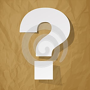Questionmark white on a crumpled paper brown background photo