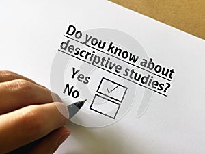 Questionnaire. One person is answering question about research. The person knows about descriptive studies