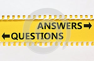 Questions and answers symbol. Concept word Questions Answers on beautiful yellow paper. Beautiful white paper background. Business